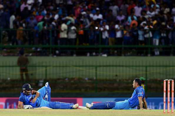 Dhoni and Rohit lay sprawled on the ground after crowd trouble stopped the match