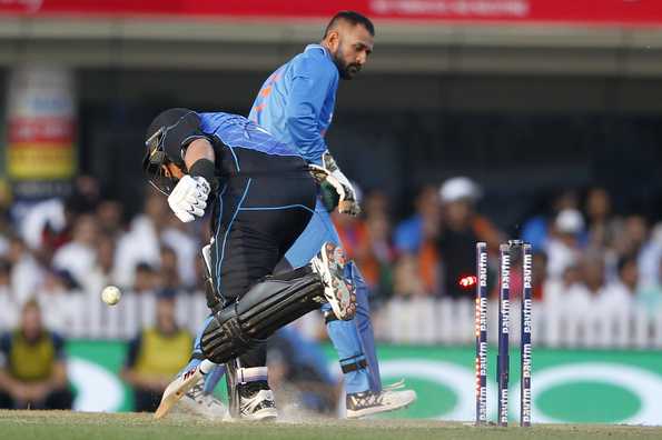 The trademark Dhoni flick caught Ross Taylor inches short of the crease