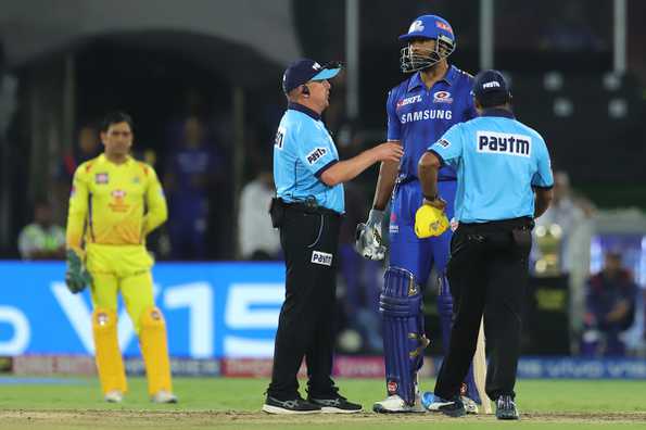 The umpires have a chat with Pollard during the final