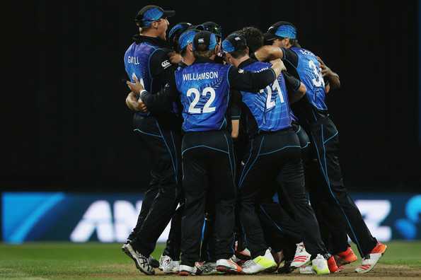 Players celebrate after picking the final wicket.