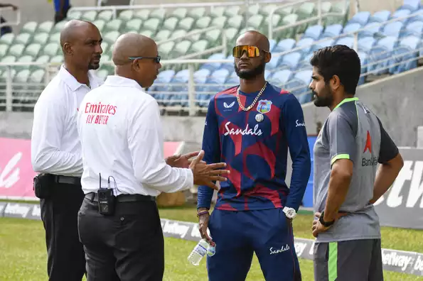 The umpires in discussion with the captains of both teams