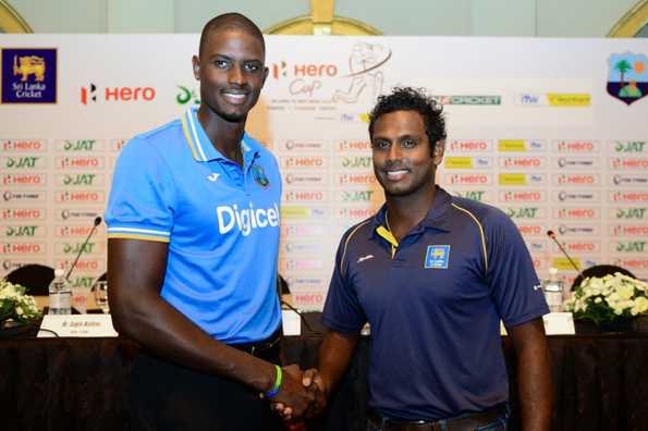 West Indies captain Jason Holder and Sri Lanka's captain Angelo Mathews shake hands at a press conference in Colombo.