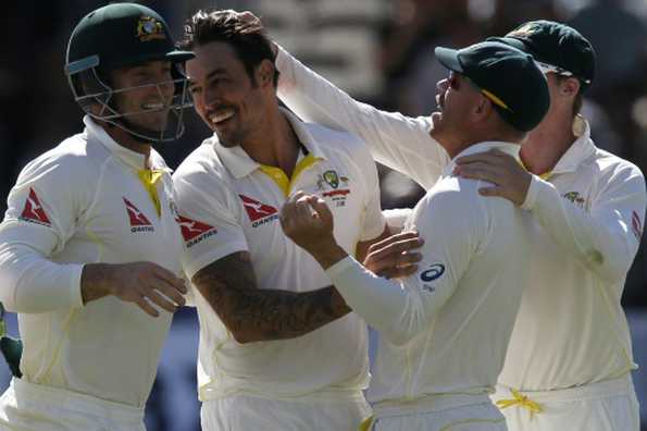 Australia's Mitchell Johnson (C) celebrates taking the wicket of England's Jos Buttler on the fourth day of the second Ashes Test at Lord's in London, on July 19, 2015