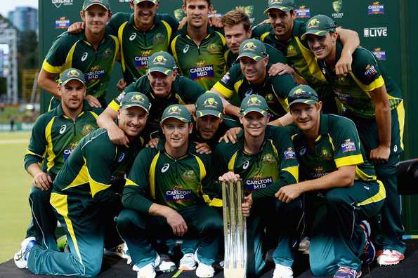 The Australian team pose with the Carlton Mid tri-series trophy.