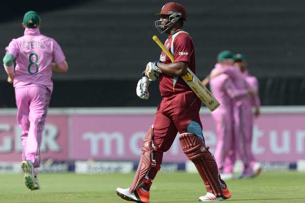 A dejected Dwayne Smith walks back to the pavilion after he was dismissed for a fine 64.