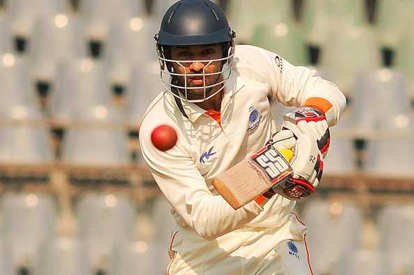 Naman Ojha's 54 steadied Madhya Pradesh until a collapse just before tea brought Karnataka back.