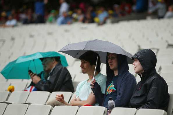 The umbrellas were out as it started raining at MCG.