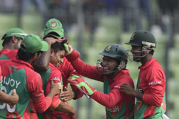 Bangladesh cricketers congratulate teammate Taijul Islam (C) after his hat-trick.