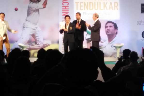 Sachin Tendulkar poses with a copy of the book.