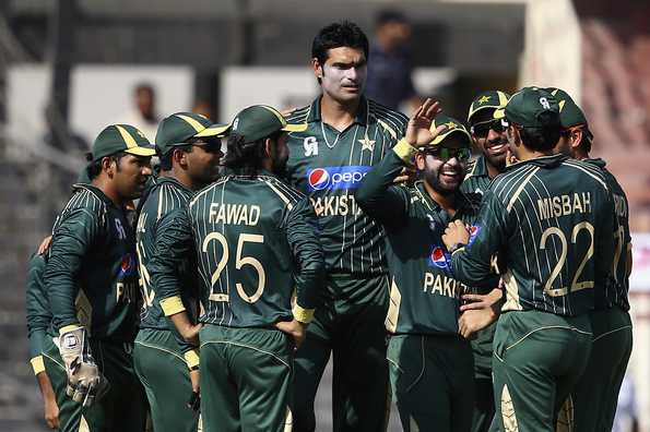 Muhammed Irfan celebrates with teammates after dismissing Aaron Finch.