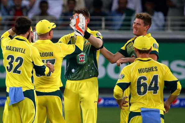 Australian team members celebrate after Awais Zia was caught out.