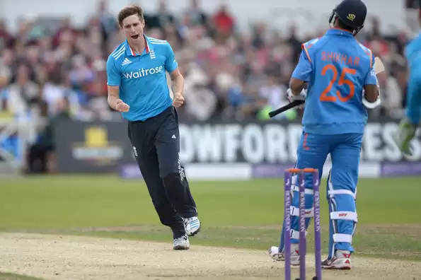 Chris Woakes celebrates after dismissing Shikhar Dhawan.