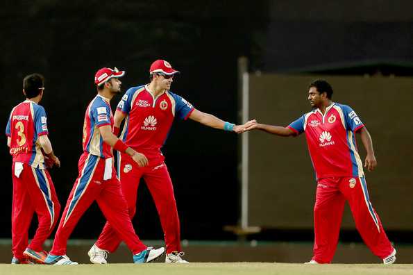 Mitchell Starc and Muttiah Muralitharan celebrate the wicket of David Hussey.