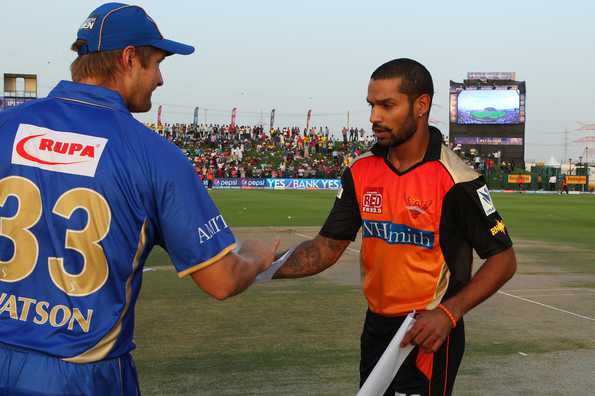 Shane Watson captain of the Rajatshan Royals and Shakhar Dhawan swap team sheets prior to the toss