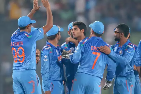 Bhuvneshwar Kumar is congratulated by his team-mates after dismissing Quinton de Kock.