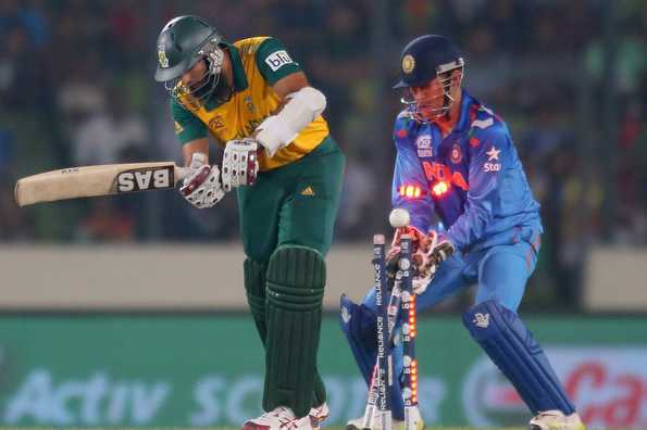 Hashim Amla is out bowled as MS Dhoni of India looks on.