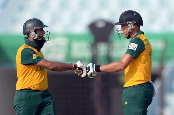 South Africa batsman Faf du Plessis (R) congratulates Hashim Amla after a boundary during the ICC World Twenty20 tournament cricket match between South Africa and Netherlands at The Zahur Ahmed Chowdhury Stadium in Chittagong on March 27, 2014. 