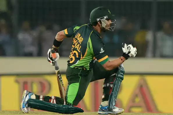 Umar Akmal reacts after victory in the eighth match of the Asia Cup.