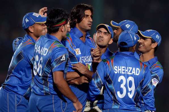 Afghanistan players celebrate after picking up a wicket.