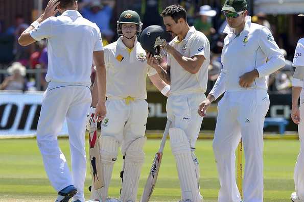 Mitchell Johnson checks his helmet after being hit by a Morne Morkel bouncer.