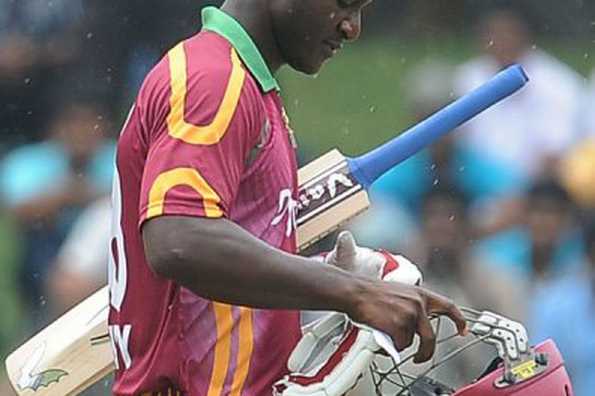 West Indies captain Darren Sammy walks back to the pavilion after his dismissal during the second one-day international against Sri Lanka at the Sinhalese Sports Club (SSC) Cricket Ground in Colombo on February 3. Egos to the left of him, record-setters to the right: Sammy, unheralded captain of the West Indies, faces mission impossible at the World Cup.