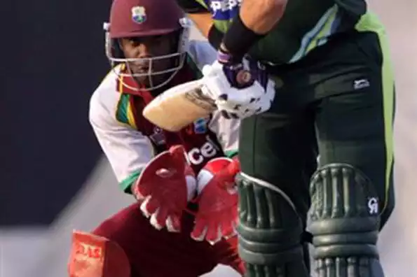 Pakistan batsman Misbahul Haq plays a delivery as West Indies wicket-keeper Xavier Marshall looks on during their third and final one-day international cricket match in Abu Dhabi. Rao Iftikhar returned career-best bowling figures while Younus Khan struck a brilliant hundred to guide Pakistan to a 31-run win over the West Indies in the third and final one-day here on Sunday.