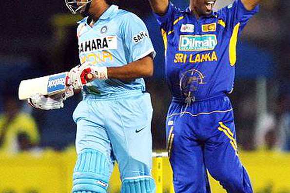 Sri Lankan cricketer Nuwan Kulasekara(R) celebrates after the dismissal of Indian batsman Rohit Sharma(L) during their fifth and final One Day International match in Colombo. India, who already had a winning 3-1 lead, were shot out for 103 chasing a rain-revised target of 216 off 44 overs under lights. They clinched the series 3-2.