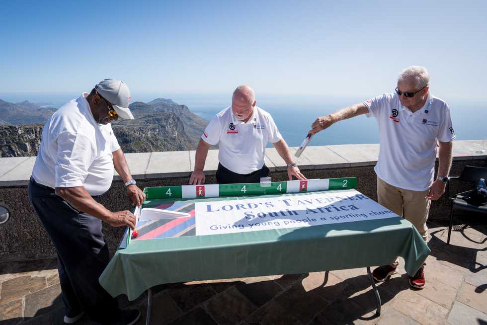 David Gower drives Jeremy Fredericks' deliveries while Mike Gatting patrols midwicket in a game of table cricket played atop Table Mountain. (Photo credit: Mark Sampson)